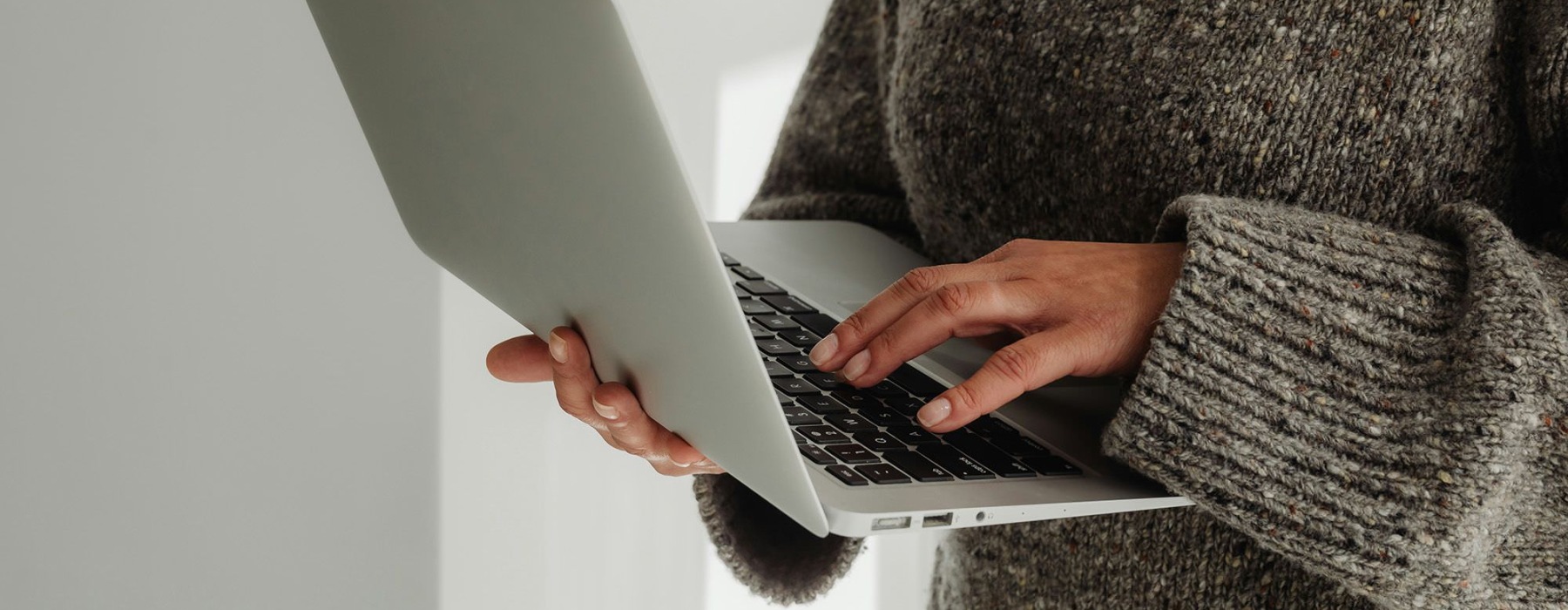 A person holding a laptop.