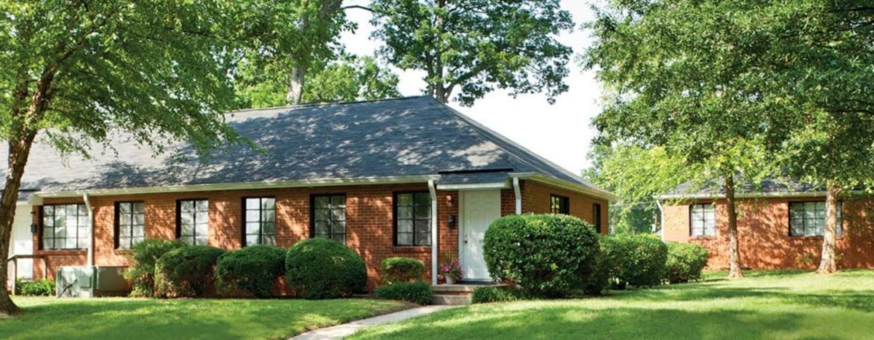 a brick house with a driveway